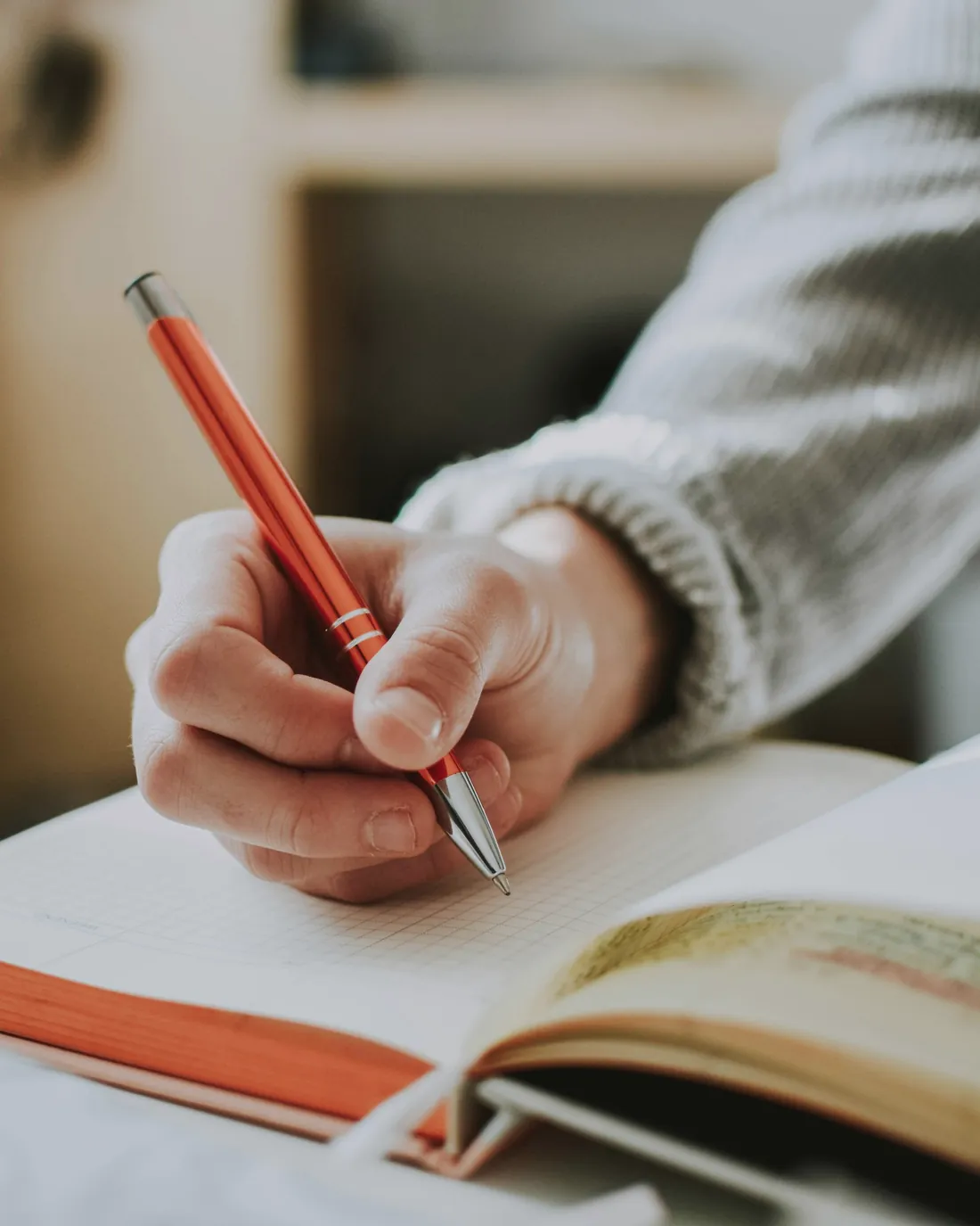 A person editing printed pages with a pen